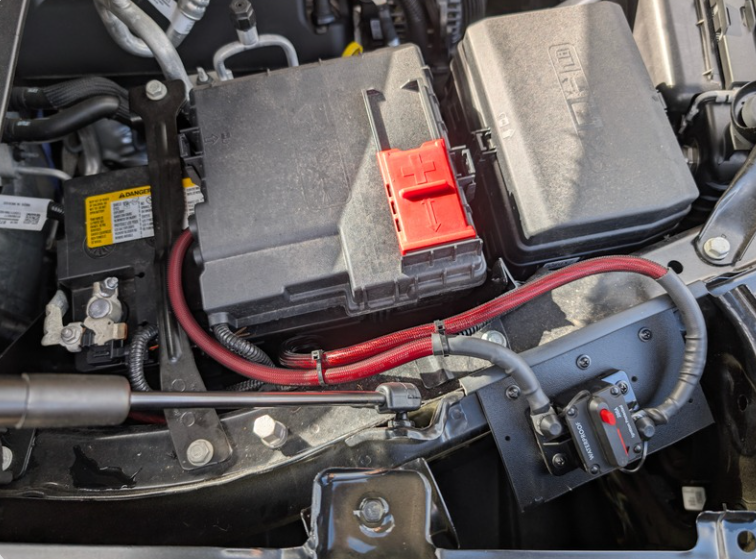 Engine-bay battery with heavy power cable and a red terminal cover