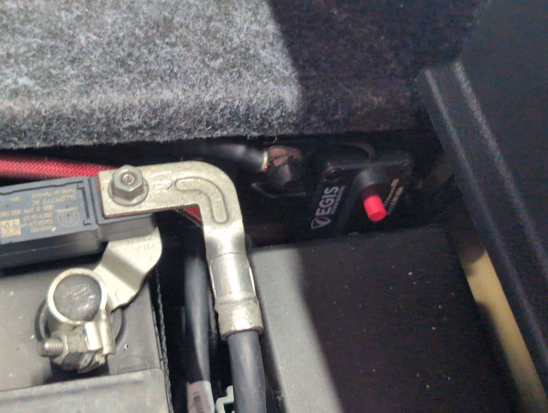 Battery terminal with a heavy cable and lug in a vehicle compartment